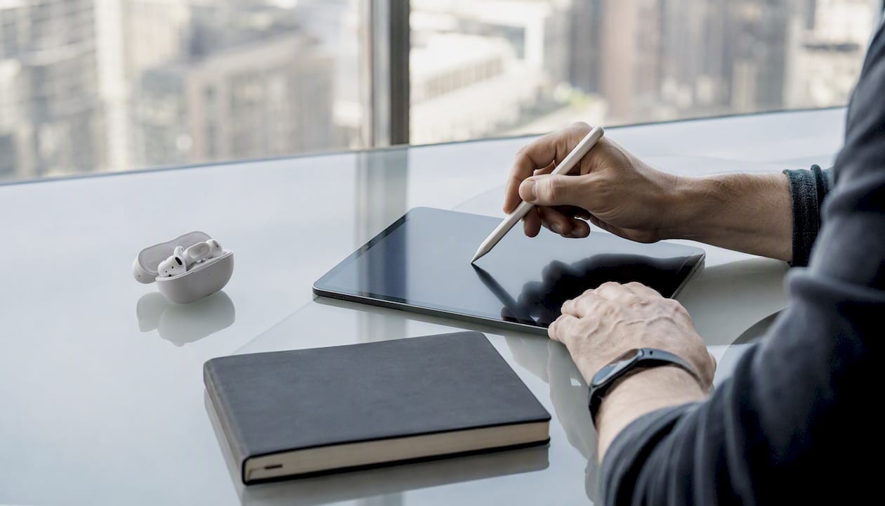 Hands interacting with tablet for networking