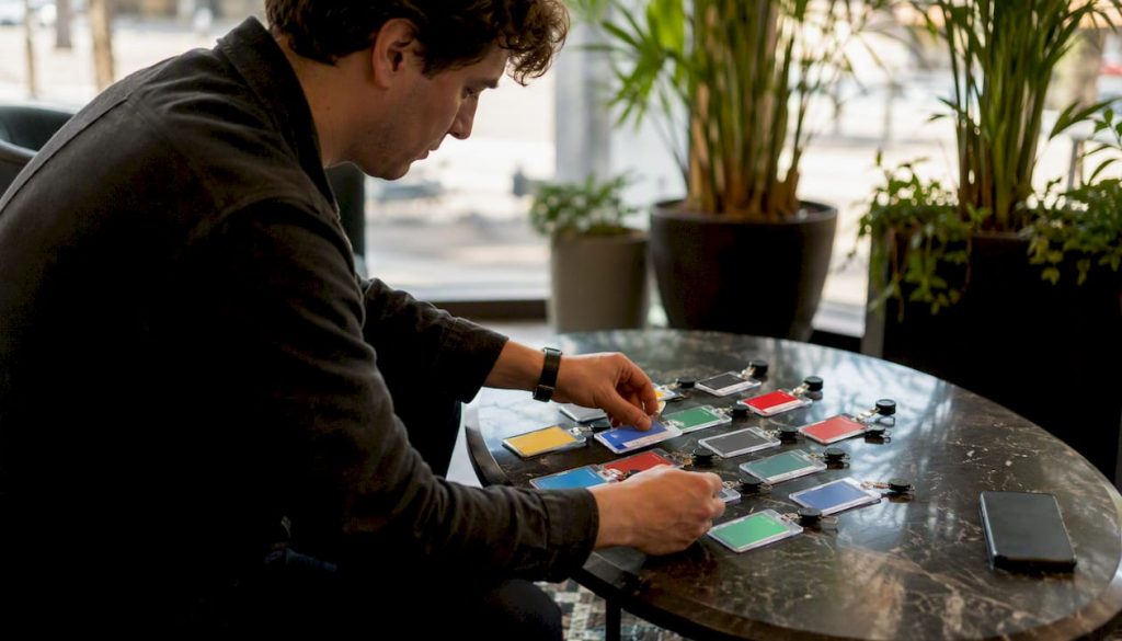 Hands selecting LinkedIn access badges on desk