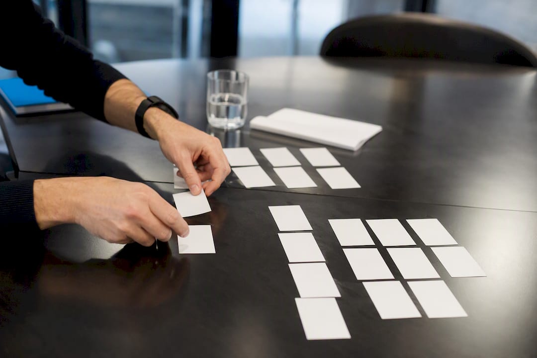 Hands sorting prospect targeting cards