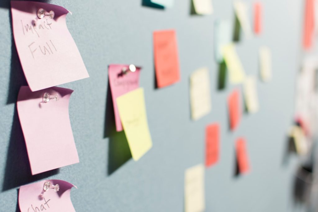 Colorful sticky notes pinned to a board during a buyer persona planning session