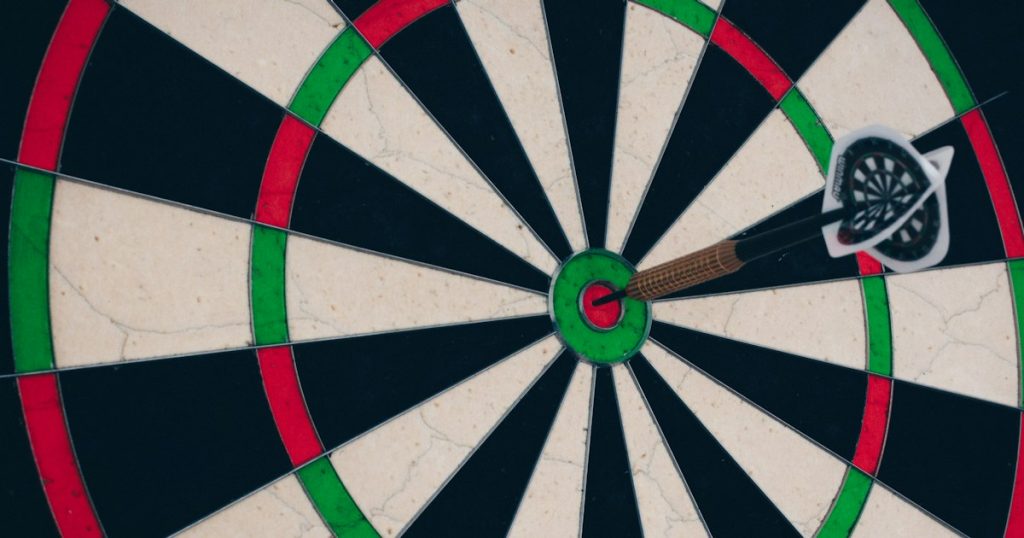 Dart hitting the centre of a target