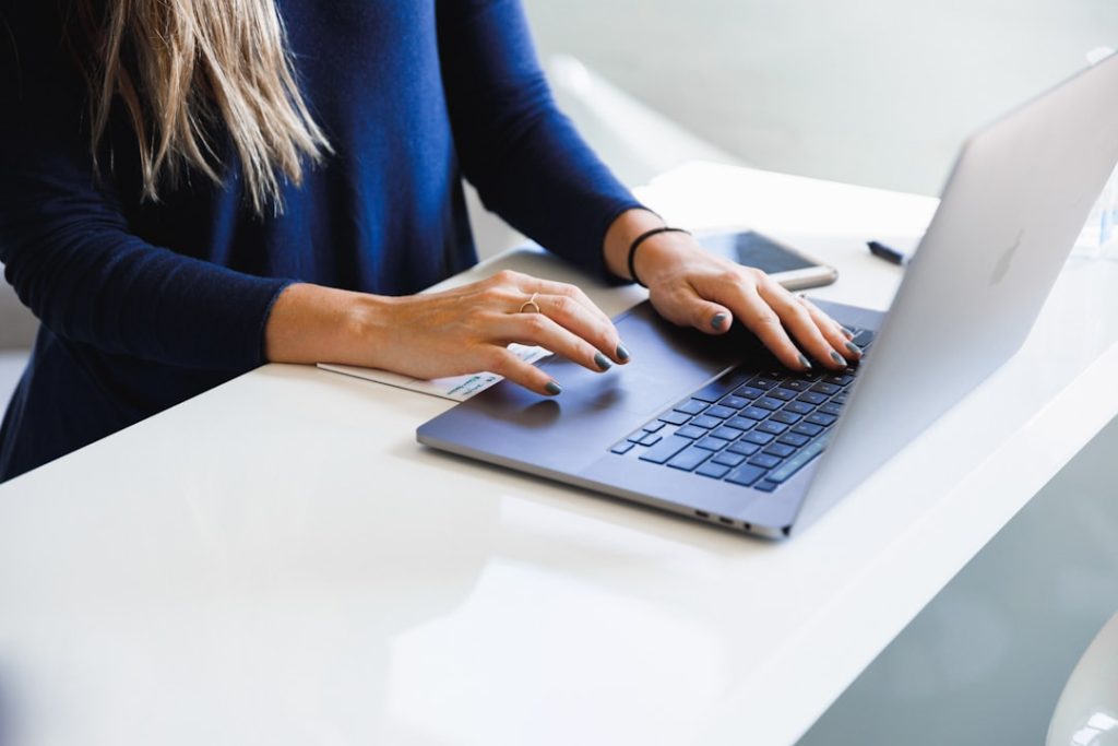 Recruiter reviewing candidate profiles on a laptop