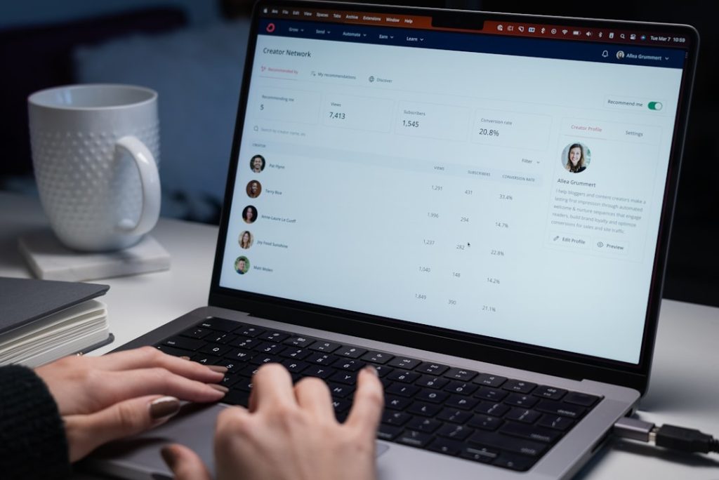 Person typing on a laptop while building an outbound sales sequence