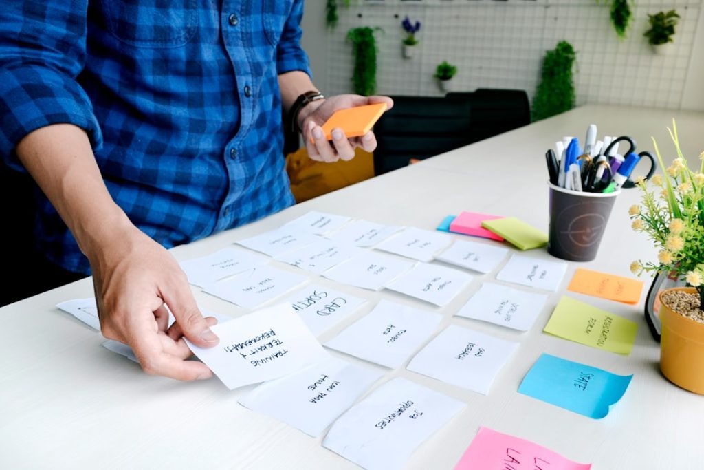 Hands sorting printed lead cards into qualification categories
