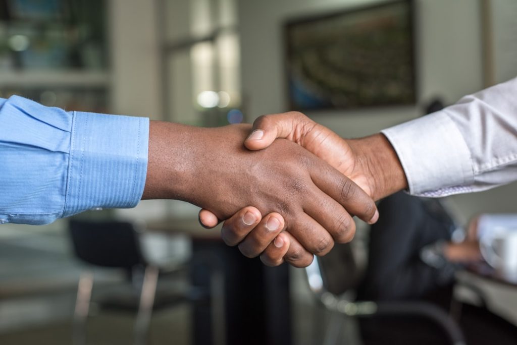Two business people shaking hands after a warm introduction
