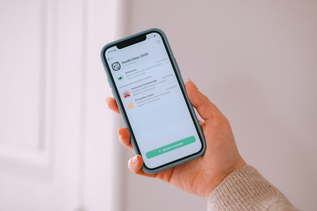 Hand holding a smartphone showing a LinkedIn notification alert