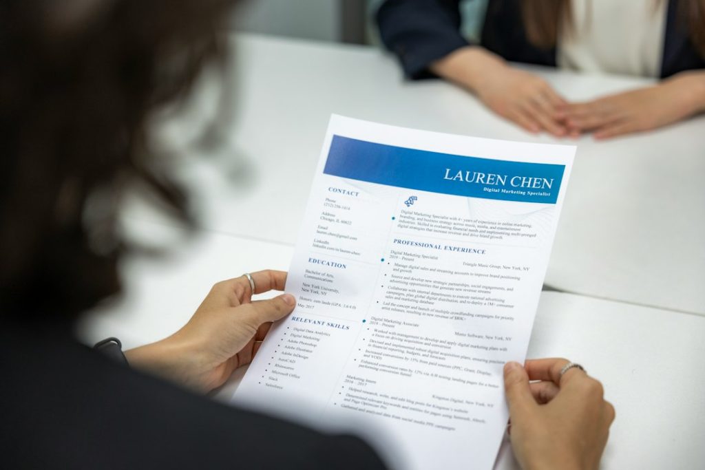 Close-up of hands reviewing a CV document to check fit against a narrow target niche