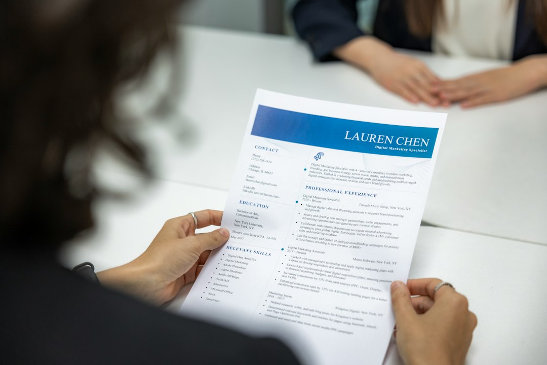 Close-up of hands reviewing a CV document to check fit against a narrow target niche